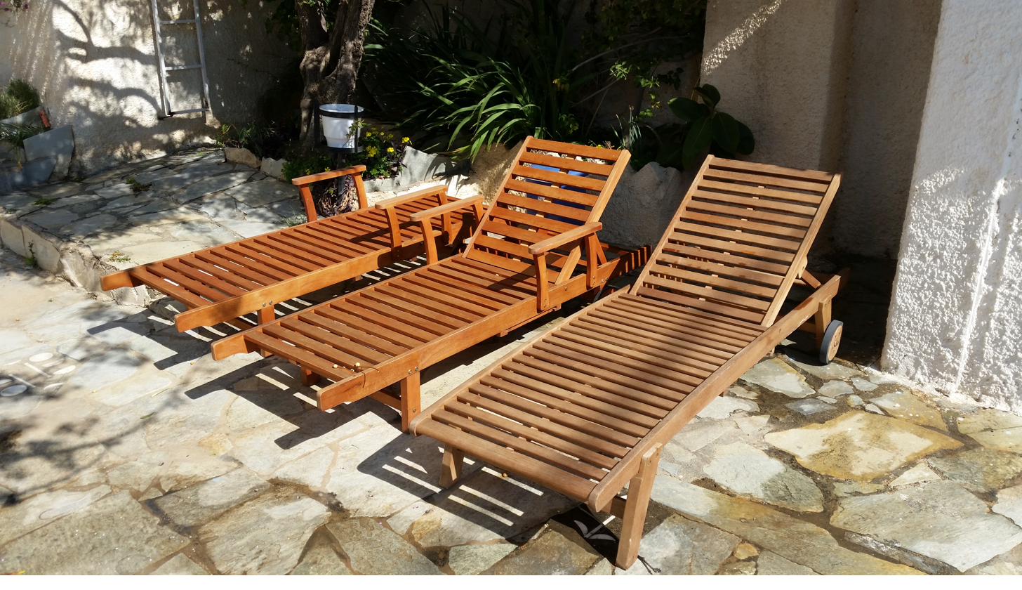 Wooden sun loungers by the pool